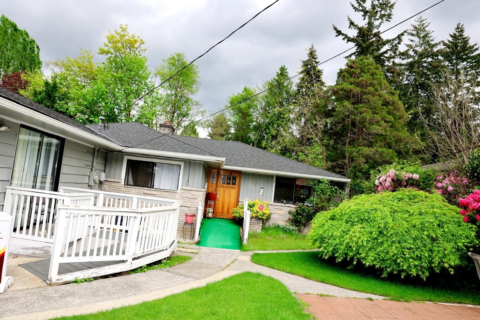 Advanced Senior Care home with accessible ramp and landscaped yard
